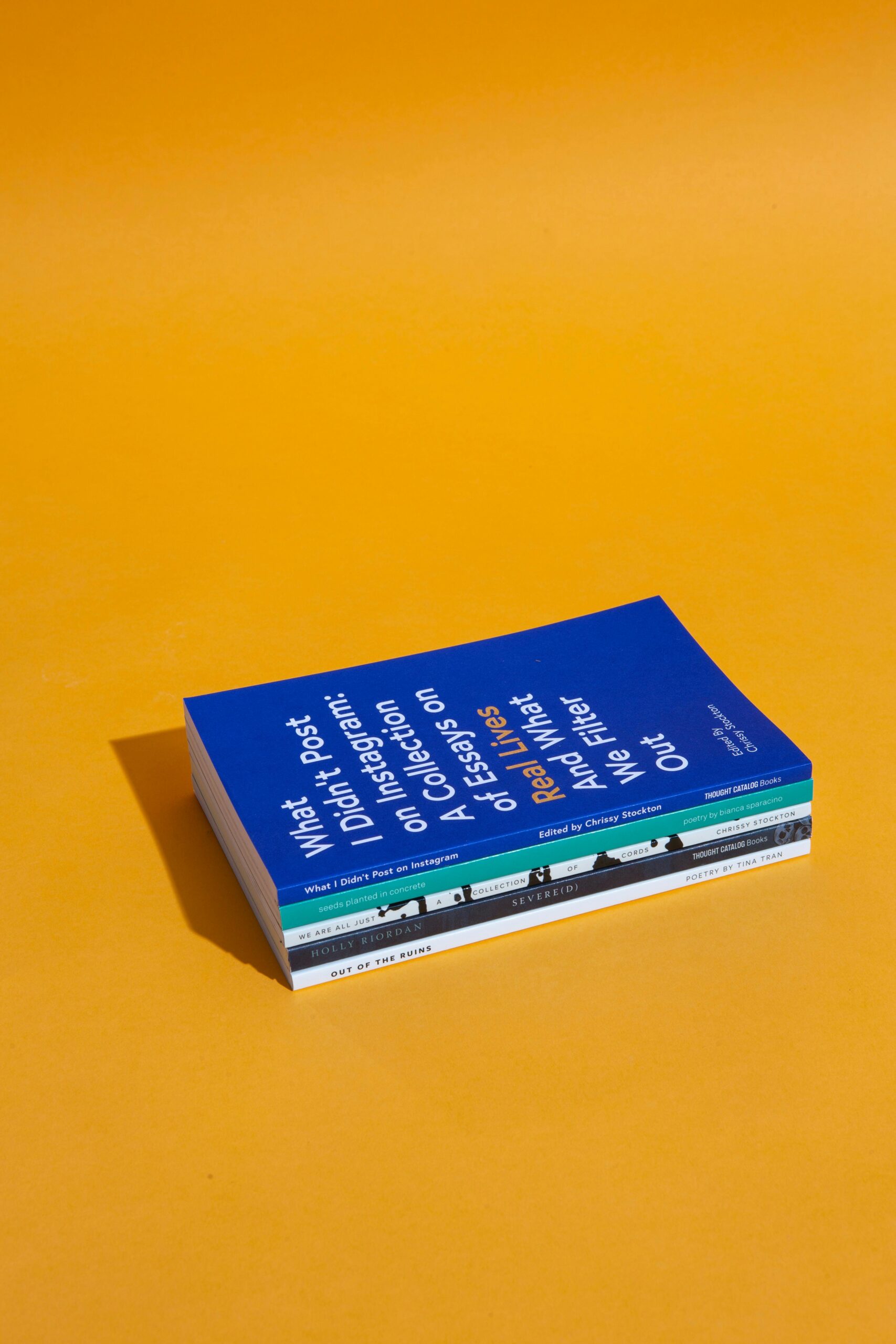 A stack of books with a bright orange background, perfect for educational themes.
